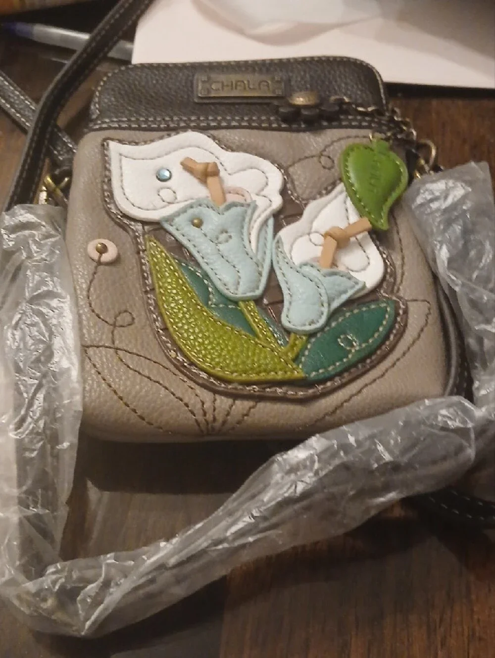 Chala Taupe Crossbody Bag with Blue, White & Green Floral Appliqué